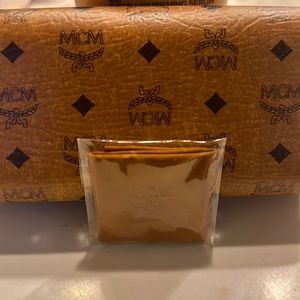 Sunglasses that are by the designer MCM and they are of a creamy color
